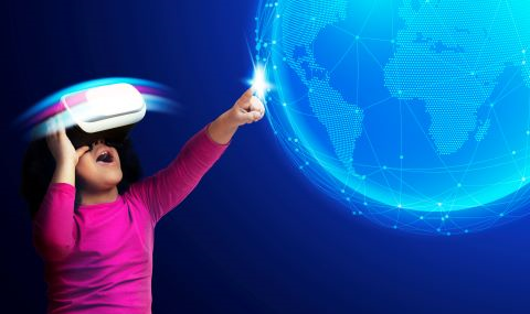 Little girl wearing a VR headset and touching the world